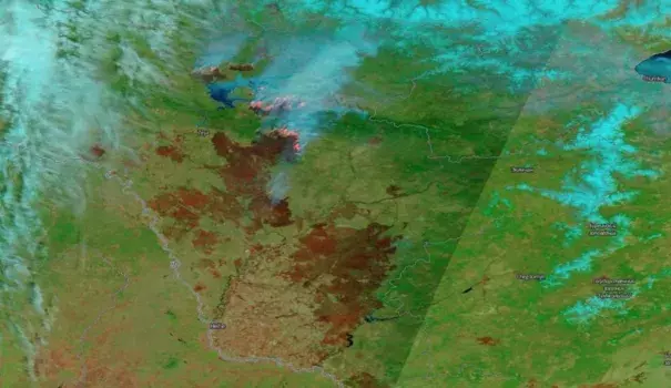 This false-color image acquired May 9, 2018 by the Moderate Resolution Imaging Spectroradiometer (MODIS) aboard NASA's Terra satellite shows wildfires burning in Siberia, in orange. Burn scars from these wildfires can be seen in brown. Image: NASA