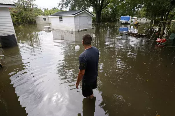 Chris Landaiche looking out to his flooded backyard in Sorrento, Louisiana, on Sunday. Photo: Jonathan Bachman, Reuters