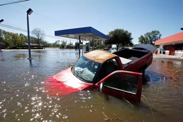 An abandoned truck lies in submerged waters after Hurricane Matthew hit Lumberton, North Carolina. Photo: Jonathan Drake / Reuters