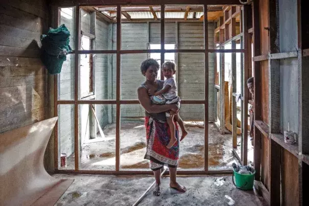 Kolora, 26, holds her daughter Semaima, 2, in what is left of her home in the aftermath of Tropical Cyclone Winston in Rakiraki district in Ra province of Fiji. Photo: UNICE