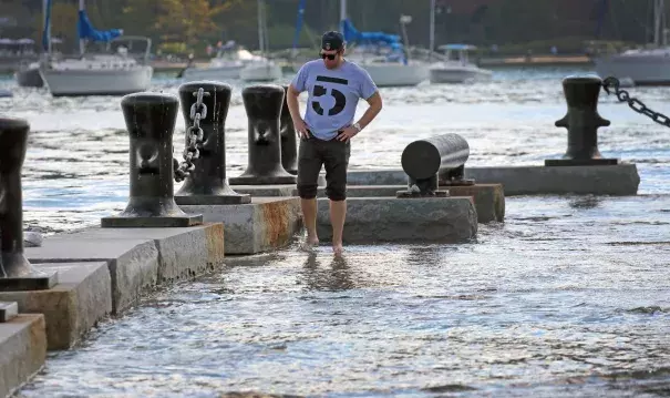 Andrew Dzurovcik was visiting Boston from Chicago when he spotted the high tides at Long Wharf. Photo: The Boston Globe