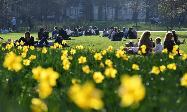 Park goers enjoy the warm winter weather in St. James’s Park in London. The hottest winter day on record has been recorded in Britain for a second day running. Photo: Andy Rain, EPA