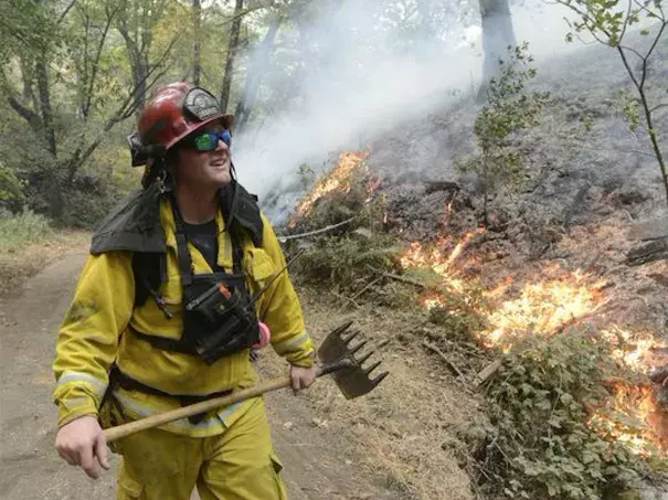 Rancho Adobe Fire Captan James Devrloo keeps an eye on a fire line on Garza Trail in the Rancho San Carlos Community as a wildfire burns in Carmel Valley, Calif. July 27, 2016. Photo: David Royal, The Monterey County Herald via AP