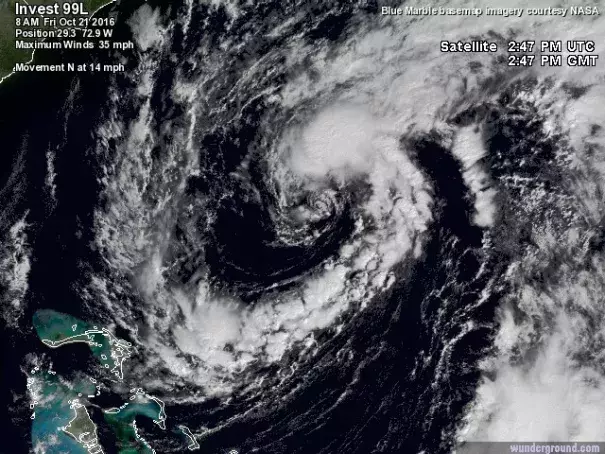 A broad loop of showers and thunderstorms is spiraling into 99L, shown here in a visible satellite image from 10:45 am EDT Friday, October 21, 2016. Image: NASA