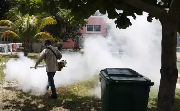 A Miami-Dade County mosquito control inspector sprays pesticide in the Wynwood neighborhood. Photo: Joe Raedle / Getty Images