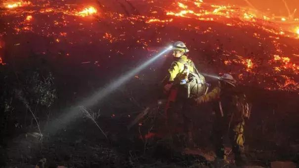 U.S. Forest Service firefighters cut brush near houses in northern Wenatchee, Wash. (Don Seabrook / Wenatchee World)
