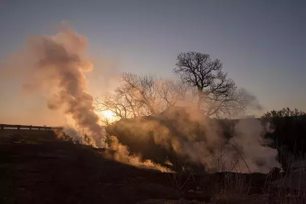 Smoke rises along US Route 160, west of Medicine Lodge, Kansas, following a wildfire that ravaged the area, March 26, 2016. The blaze, which has scorched nearly 400,000 acres, is said to be the largest recorded wildfire in the state’s history and has prompted a vast mobilization of firefighters rarely seen in this state. Photo: Craig Hacker, The New York Times