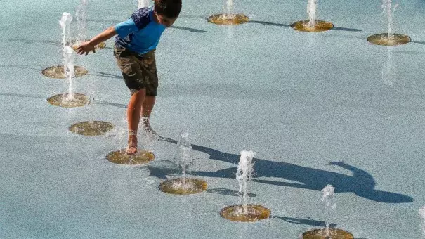 One person uses the CityScape splash pad to stay cool as temperatures climb to near-record highs Tuesday, June 20, 2017, in Phoenix. The National Weather Service forecasts a high of 120 degrees (49 degrees Celsius), which is has only hit three times in recorded history in Phoenix, the last time 22 years ago. Photo: Ross D. Franklin, AP