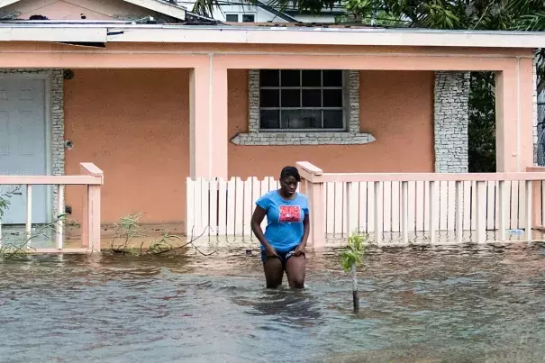 A woman walks in a flooded street after the effects of Hurricane Dorian arrived in Nassau, Bahamas. Photo: Reuters