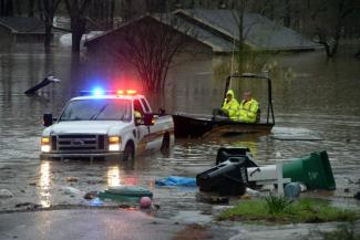 Bossier Parish Sherrif's deputies search for people that may be stranded in the homes in Shreveport, La., on Wednesday, March 9, 2016. Dozens of homes were flooded and scores of residents were evacuated. Photo: Douglas Collier, The Shreveport Times via AP
