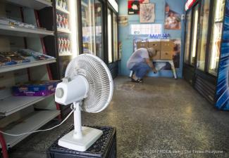 Fadi Abuali, owner of Busy Bee Food Store on Orleans Avenue, uses a small fan to dry out his store in New Orleans on Sunday, August 6, 2017 following an unexpectedly heavy rain on Saturday. He said he stayed at his store till 2 am because he couldn't leave due to the flooded streets. Photo: Chris Granger, NOLA.com | The Times-Picayune
