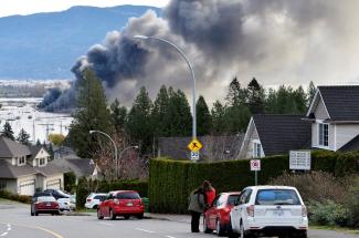 A fire last week in Abbotsford, in British Columbia near the United States border. Days earlier rainstorms lashed the province, prompting landslides and floods and closing highways. (Credit: Jennifer Gauthier/Reuters)