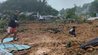 Fallen homes and rescue efforts underway in Indonesia.