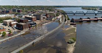 The Mississippi River, which gushed into downtown Davenport, Iowa, at record levels two weeks ago, has finally retreated toward its banks. Credit: Daniel Acker for The New York Times