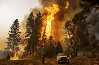 FILE - A firefighter monitors a backfire, flames lit by fire crews to burn off vegetation, while battling the Mosquito Fire in the Volcanoville community of El Dorado County, Calif., on Sept. 9, 2022. Drought and wildfire risks will remain elevated in the western states while warmer than average temperatures will greet the Southwest, Gulf Coast and East Coast this winter, federal weather officials said Thursday, Oct. 20. (Credit: AP Photo/Noah Berger, File)