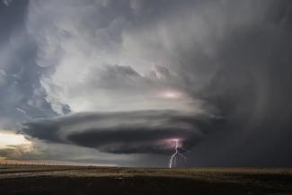 Dark clouds are pictured with a supercell and lightning bolt.