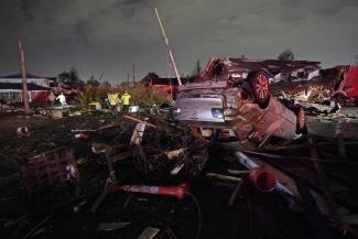 FILE - A car is flipped over after a tornado tore through the area in Arabi, La., Tuesday, March 22, 2022, in a part of the city that had been heavily damaged by Hurricane Katrina 17 years earlier. A United Nations report released on Monday, April 25, 2022, says disasters are on the rise are just going to get worse. A new UN report says the number of disasters, from climate change to COVID-19, are going to jump to about 560 a year by 2030. (Credit: AP Photo/Gerald Herbert, File)