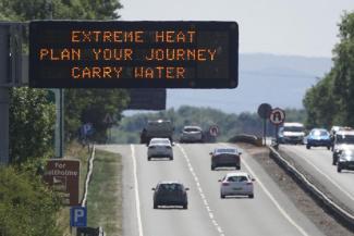 A matrix sign over the A19 road towards Teesside displays an extreme weather advisory as the UK braces for the upcoming heatwave, in England, Saturday July 16, 2022. (Credit: Owen Humphreys/PA via AP)
