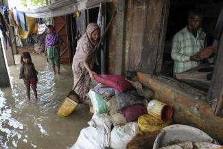 People inspect the damaged belongings in their homes as flood water levels recede slowly in Sylhet, Bangladesh, Wednesday, June 22, 2022. (Credit: AP Photo/Mahmud Hossain Opu)