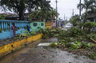 Children passes run by a street full of remains of trees broke by Hurricane Julia in Bluefields, Nicaragua, Sunday, Oct. 9, 2022. Hurricane Julia hit Nicaragua's central Caribbean coast on Sunday and dumped torrential rains across Central America before an expected reemergence over the Pacific. (AP Photo/Inti Ocon)