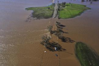 Three vehicles are submerged on Dillard Road west of Highway 99 in south Sacramento County in Wilton, Calif., Sunday, Jan. 1, 2023, after heavy rains on New Year's Eve produced levee breaks. (Credit: Hector Amezcua/The Sacramento Bee via AP)