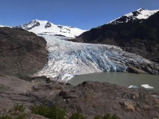FILE - Chunks of ice float on Mendenhall Lake in front of the Mendenhall Glacier on Monday, May 30, 2022, in Juneau, Alaska. (Credit: AP Photo/Becky Bohrer)