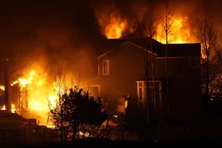 Homes burn as wildfires rip through a development Thursday, Dec. 30, 2021, in Superior, Colo. (AP Photo/David Zalubowski)