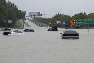 Stalled cars sit abandoned on the flooded Interstate 635 Service Road on Monday, Aug. 22, 2022, in Mesquite, Texas. The National Weather Service issued a flash flood warning early Monday morning which was extended until 1 p.m. (Credit: Elías Valverde II/The Dallas Morning News via AP)