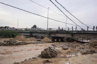 Belongings and debris are washed up by a bridge as residents clean up following torrential rains in Kinshasa,Democratic Republic of Congo Tuesday Dec. 13, 2022. At least 100 people have been killed and dozens injured by widespread floods and landslides caused by the rains. (Credit: AP Photo/Samy Ntumba Shambuyi)