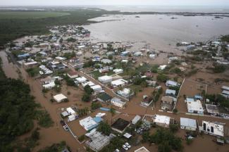 Homes are flooded on Salinas Beach after the passing of Hurricane Fiona in Salinas, Puerto Rico, Monday, Sept. 19, 2022. (AP Photo/Alejandro Granadillo)