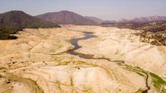 A nearly empty Lake Oroville is seen from above in Oroville, California on September 5, 2021. (Credit: Josh Edelson/AFP/Getty Images)