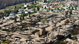Remains of burned homes are seen in a neighborhood in Fort McMurray, Alberta, on Friday, May 13. Photo: CNN