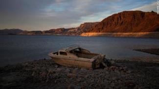 A formerly submerged boat sits high and dry along the shoreline of Lake Mead. (Credit: CNN)
