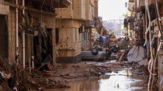 Overturned cars lay among other debris caused by flash floods in Derna, eastern Libya, on September 11, 2023. (Credit: AFP/Getty Images)