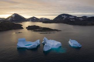 In this August 16, 2019 photo, large icebergs float away as the sun rises near Kulusuk, Greenland. Scientists are hard at work trying to understand the rapid melting of the ice. Credit: Felipe Dana, AP