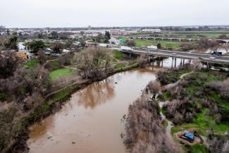 The Tuolumne River flows under highway 99 near Modesto, California, after downpours. (Credit: Marty Bicek/Zuma Press Wire/Rex/Shutterstock)