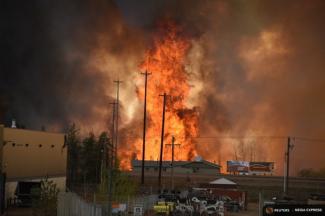 Flames rise in Industrial area south Fort McMurray, Alberta Canada May 3, 2016. Photo: CBS News, Reuters