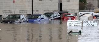 Flooded cars parked next to the Peterson Paper Loft Apartment building on Pershing Avenue at East 2nd Street in Davenport after a flood barrier was breached by Mississippi floodwaters on Tuesday. Credit: John Schultz