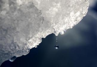 FILE - A drop of water falls off an iceberg melting in the Nuup Kangerlua Fjord near Nuuk in southwestern Greenland, Tuesday, Aug. 1, 2017. Earth’s poles are undergoing simultaneous freakish extreme heat with parts of Antarctica more than 70 degrees (40 degrees Celsius) warmer than average and areas of the Arctic more than 50 degrees (30 degrees Celsius) warmer than average. (Caption & Photo Credit: AP Photo/David Goldman, File)