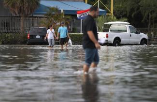 North Miami, Florida was flooded due to the effects of the magnified high tide of this week's unusually close full Moon. That, and the effects of decades of sea level rise due to global warming. Photo: Joe Raedle, Getty Images
