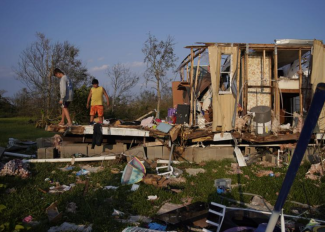 Aiden Locobon and Rogelio Paredes look through the remnants of their family's home destroyed by Hurricane Ida, September 4, 2021 in Dulac, LA. Credit: John Locher, AP