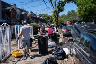 On Peck Avenue in Queens, residents tossed out items ruined by flooding. (Credit...Gregg Vigliotti for The New York Times)
