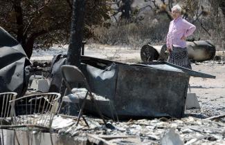 Ki Jo So returns to her home and property burned by the Blue Cut Fire off of the 138 for the first time Monday August 22, 2016. So, who has lived on the property for 13 years with her family, had no insurance. Photo: Will Lester