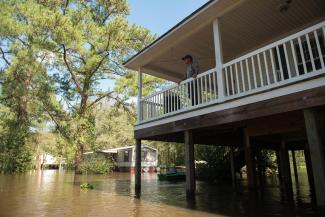 Mitch Townsend stands on the porch of his home as floodwaters from Little Swift Creek rise in Vanceboro on Oct. 10, 2016. Hurricane Matthew xxaused some major flooding in wetern parts of Craven County and throughout the eastern part of the state, flooding that even surprised forecasters, according to a report on the storm. Photo: Sun Journal File