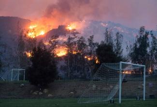 Flames from a wildfire consume the mountainside near the Cate School campus in Carpinteria, Calif., on Sunday. Photo: Kenneth Song, Santa Barbara News-Press via AP