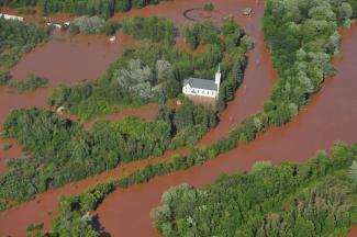 A church is surrounded by flood waters in the middle of the Bad River reservation in Odanah. Photo: Courtesy of the Bureau of Indian Affairs