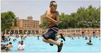A youngster takes a backward plunge into the Thomas Jefferson pool in East Harlem in New York during a citywide heat wave in July. Photo: AP