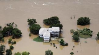 Flood waters from the Brazos River surround a home in Weatherford, Texas on Friday, May 29th. Photo: Brandon Wade, AP