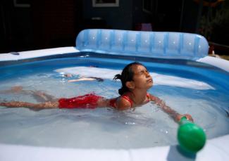 Windy Tinoco, 7, enjoys her family's outdoor inflatable pool in the front yard of their home in the Burbank neighborhood in San Jose, Calif., on Sunday, June 18, 2017. Photo: Nhat V. Meyer, Bay Area News Group