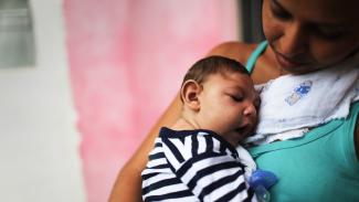 A mother holds her baby, who has microcephaly, in Recife, Brazil. Photo: Mario Tama, Getty Images